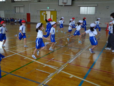下の写真は、１年２組の２０メートルシャトルランの練習の様子です。