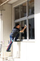 １階の外窓を拭くPTA会長さん